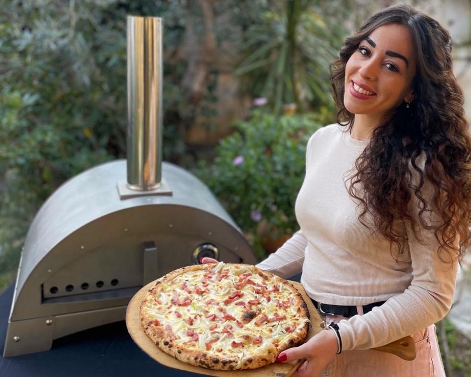 Sandra, la co-créatrice de Branner qui tient dans ses mains son four à pizza portable